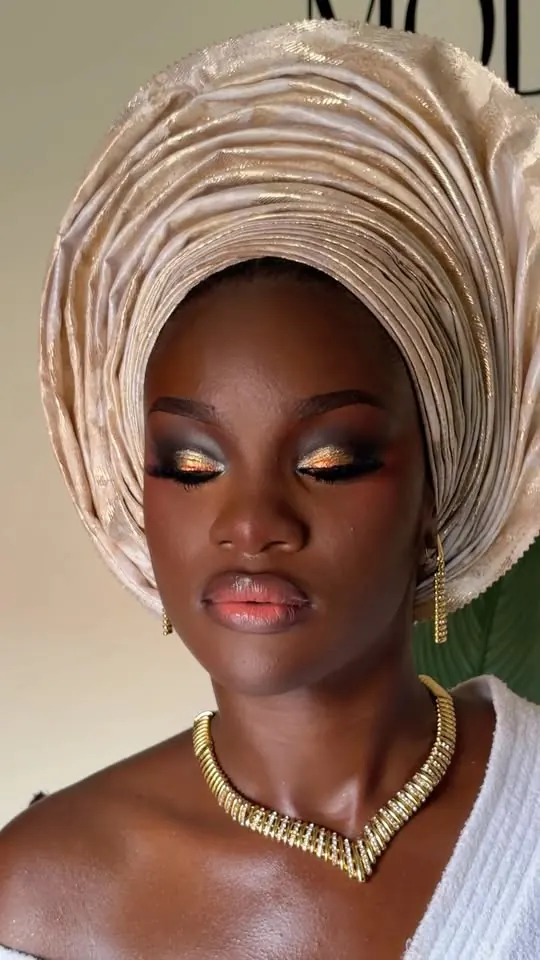 Bride in gele and soft bridal makeup by Modupe Oge