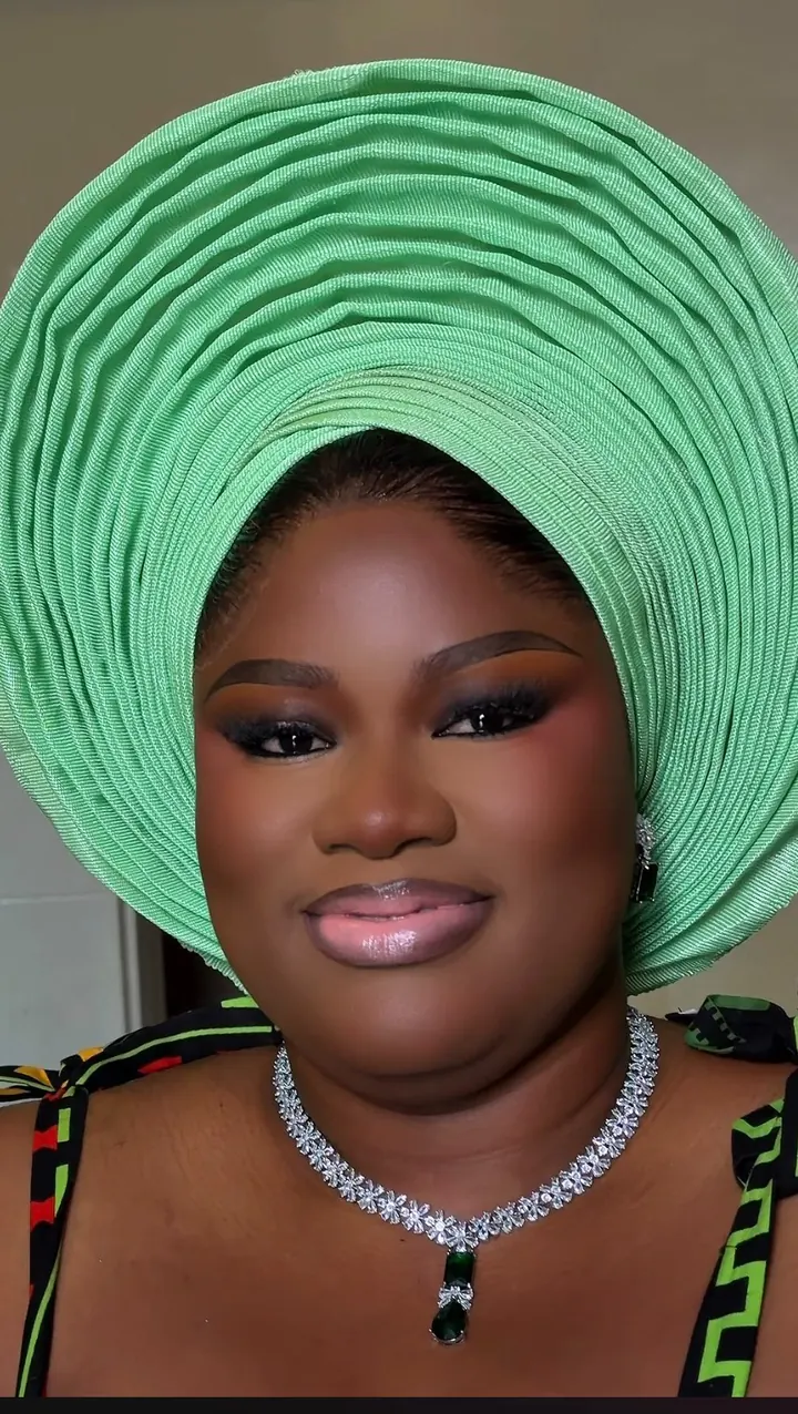 Bride in makeup and gele by Modupe Oge